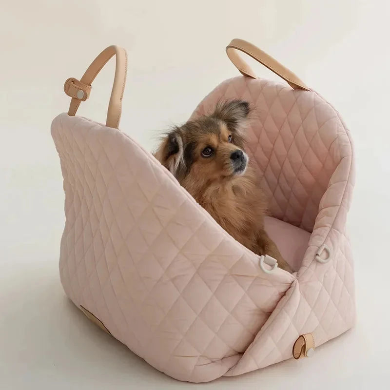 Dog lying in a pink pet carrier on a light background